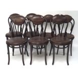 A set of seven bentwood chairs, each with faux leather upholstered seats and backs,