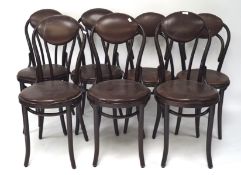 A set of seven bentwood chairs, each with faux leather upholstered seats and backs,