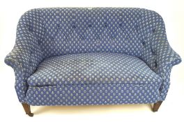 A small two seater blue upholstered sofa, with button back and arms,