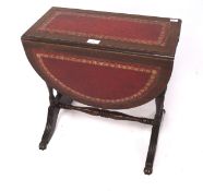 A small Victorian mahogany drop leaf table, of oval form, the top inset with red leather,