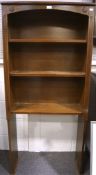 A 20th century oak bookcase, containing three shelves, the framed with carved details,