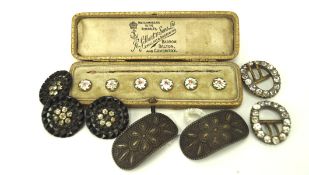 Seven vintage belt buckles and a boxed set of ceramic buttons,