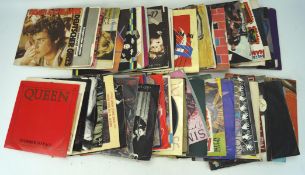 An assortment of vintage vinyl singles, including 1980s examples,