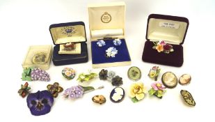 A collection of ceramic brooches, mostly modelled as flowers,