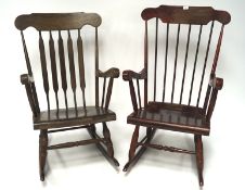 Two stained wooden rocking chairs, each with turned supports and scrolling arms,