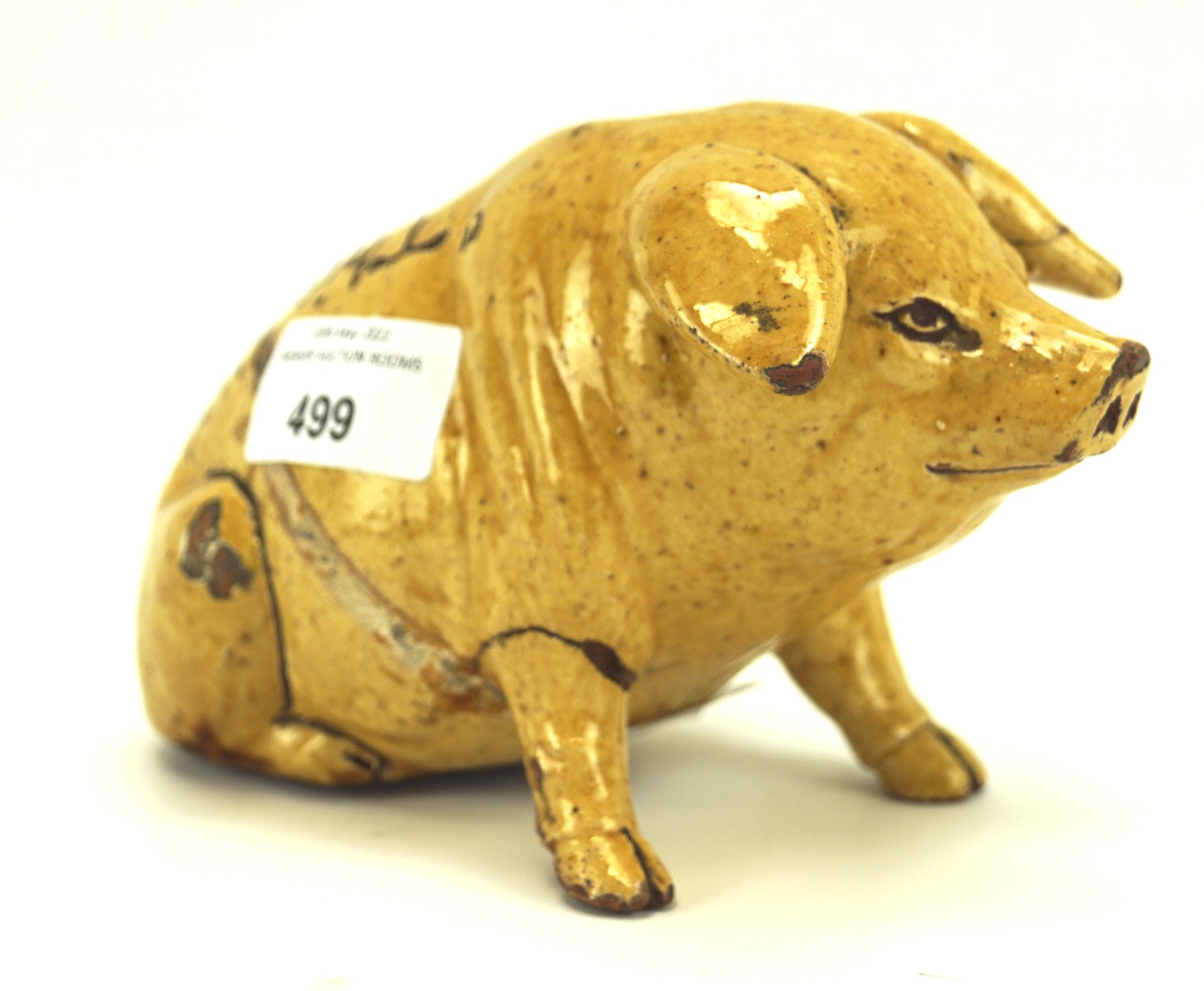 Horace Elliot for Ewenny pottery, a stoneware figure of a pig money box, of seated form,