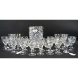 An assortment of cut glassware, including Waterford crystal, beakers, spirit glasses,