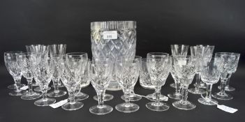 An assortment of cut glassware, including Waterford crystal, beakers, spirit glasses,