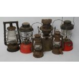 An assortment of six lamps and lanterns, including two hurricane lanterns,