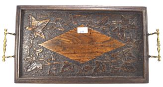 A 20th century carved oak butlers tray, the top decorated with vines and leaves, twin handled,