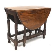 An early 20th century oak drop leaf gate leg table, raised upon turned supports,