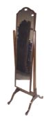 A 20th century mahogany veneer cheval mirror, raised on flowing supports,