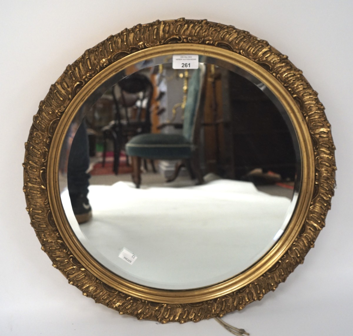 A 20th century bevelled edge wall mirror, of circular form with a gilt frame,