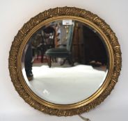 A 20th century bevelled edge wall mirror, of circular form with a gilt frame,