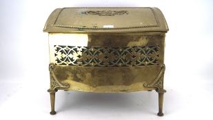 A early 20th century brass coal scuttle, with hinged lid and pierced details,