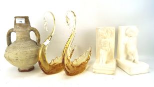 A pair of glass swans, a pair of plaster bookends and a stoneware twin-handled vase,