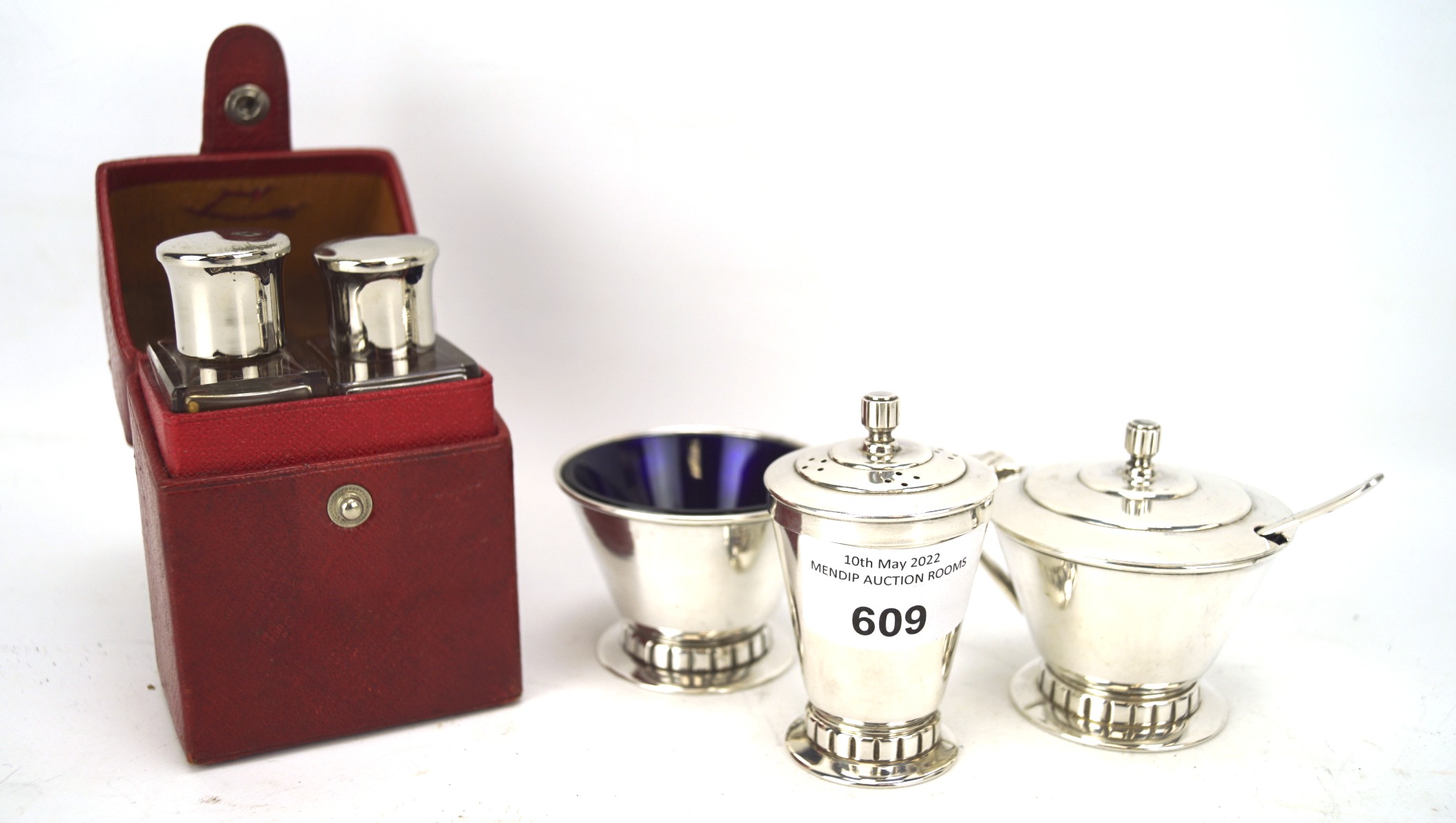 An Art Deco silver plated three piece condiment set and perfume bottles,