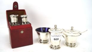 An Art Deco silver plated three piece condiment set and perfume bottles,