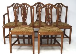 Five hooped back oak chairs, one being a carver, with pierced splats,