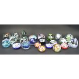 A collection of 24 glass paperweights, including two by Whitefriars,