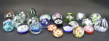 A collection of 24 glass paperweights, including two by Whitefriars,