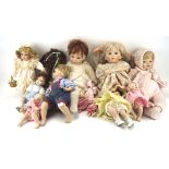 A collection of dolls, various sizes and designs,