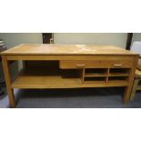 A mid-20th century beech effect work table, with single drawer, open racks and undertier,