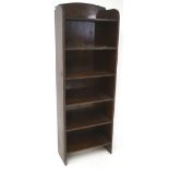 A mid-century stained wooden narrow bookcase, with six shelves,