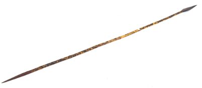 A large tribal bamboo shafted spear, with carved wooden spear end,