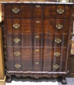 A 20th century five drawer rosewood cabinet, with a shaped front and panelled sides,