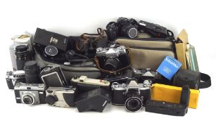 An assortment of cameras, binoculars and related accessories, including a EXA.