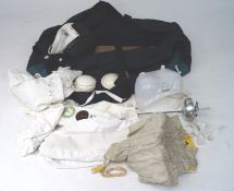 A collection of Leon Paul fencing gear in travel bag, including foil, helmet, jacket,