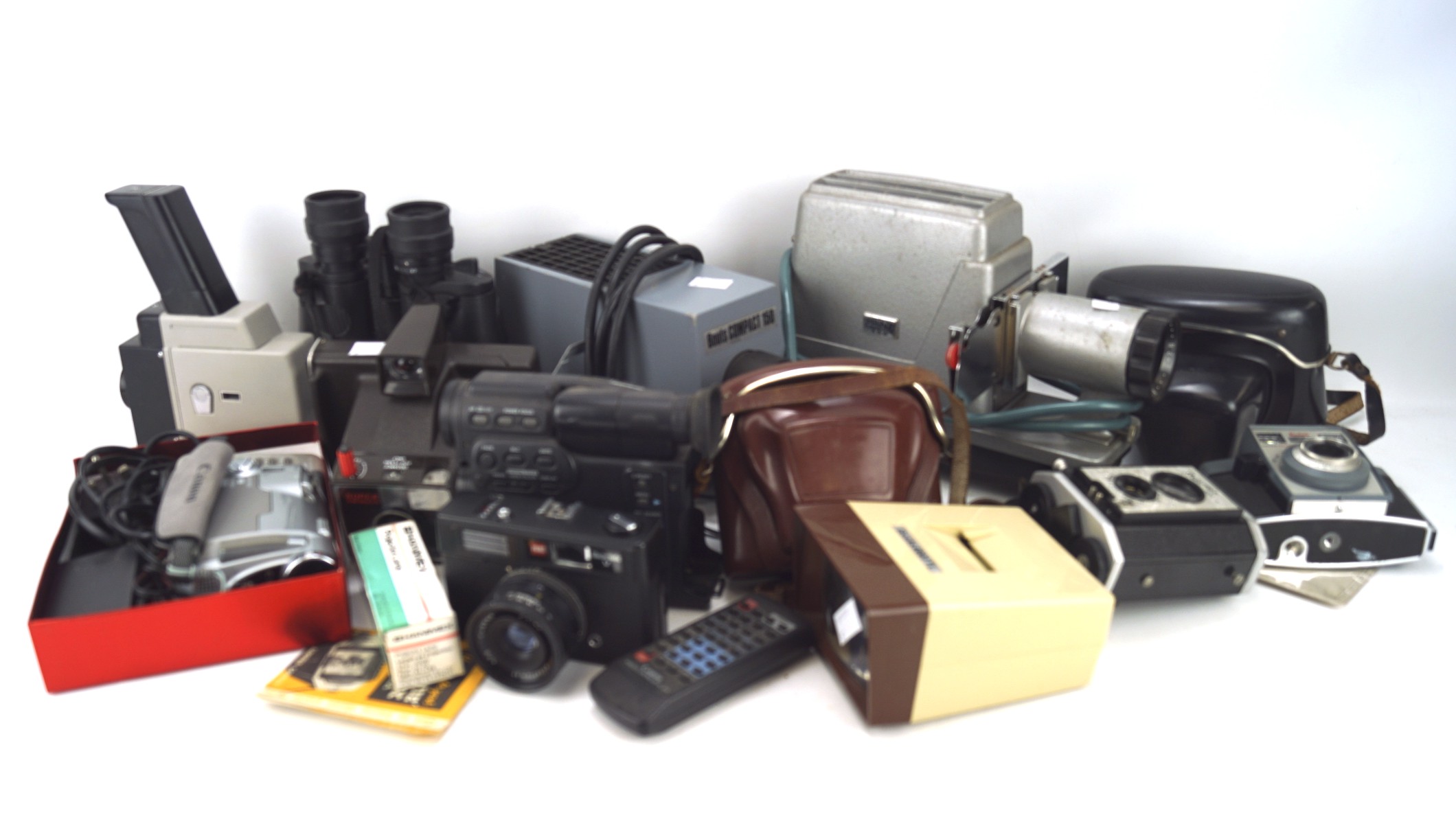 An assortment of cameras and photographic equipment, including a Kodak Auto Colorsnap 35,