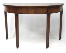 A late 19th century mahogany demi lune table, raised upon four squared tapering supports,
