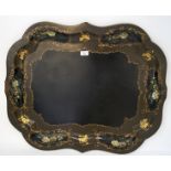 A Victorian papier mache tray, of shaped form, hand painted with cartouches containing flowers,