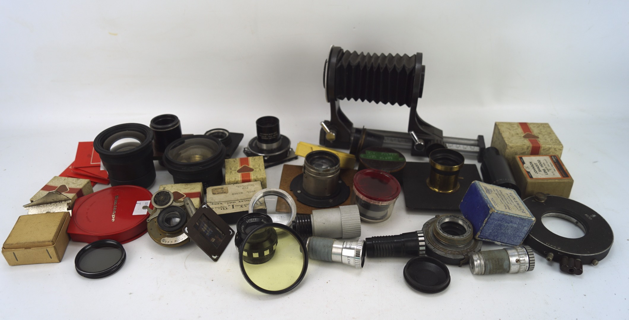 An assortment of items relating to scientific equipment, including microscope lenses, lights,