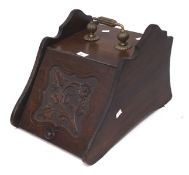 A Victorian mahogany coal scuttle with brass handle, the hinged front carved with flower,