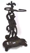 A cast metal umbrella stand, modelled as a man holding a vine,