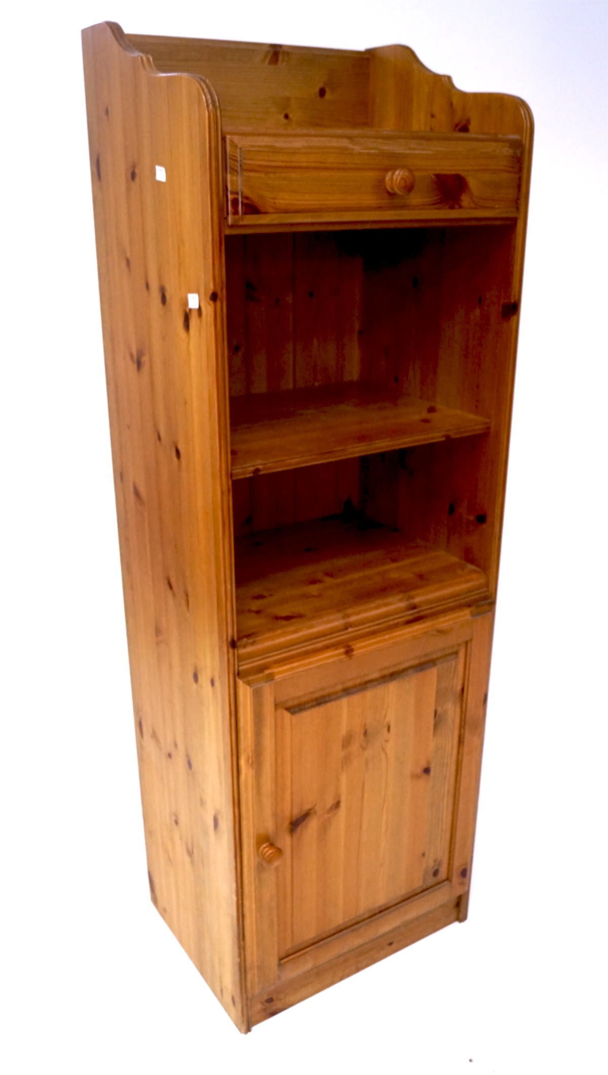 A 20th century pine unit, with single drawer over two shelves and a single door cupboard,