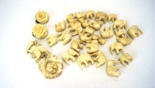 An assortment of ivory, including a floral pendant,