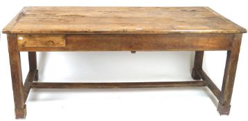 A 19th century farmhouse kitchen table, of rectangular form, raised upon four squared supports,