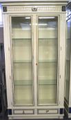 A contemporary Empire style large display cabinet, the double glazed doors with bevelled edge,