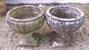 Two stone planters in the form of urns, raised on square base, max.