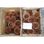 Two trays of small Victorian and later terracotta plant pots,