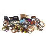 An assortment of costume jewellery, including brooches, pendants, rings,