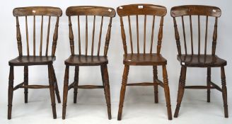 Four wooden spindle back kitchen chairs, raised on turned supports with a stretcher,