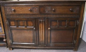 A late 19th/early 20th century oak sideboard, with carved details to the exterior,