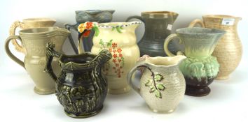 An assortment of ceramic jugs, including examples by Arthur Wood, Staffordshire, Royal Doulton, etc,