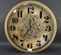 An unusual novelty wall clock with visible skeleton movement,