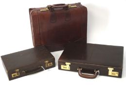 Three vintage travelling cases, comprising two briefcases and another travelling case,